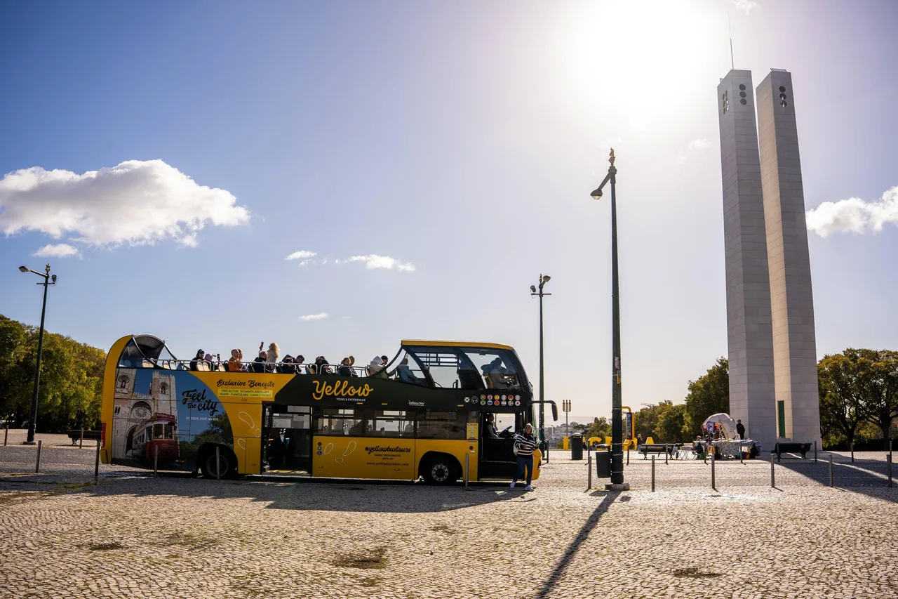 Hop-on hop-off bus tour in Lisbon passing Belém Tower
