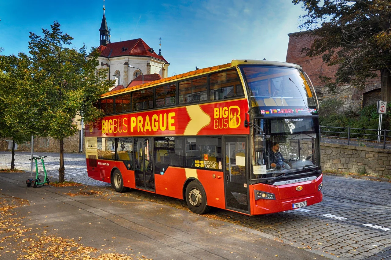 Hop-on hop-off bus tour in Prague passing Charles Bridge